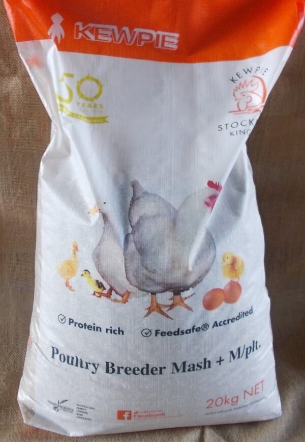 This is an image of a bag of poultry feed. The bag is labeled "KEWPIE" and mentions "50 years" and "Stockfeed King." It highlights that the feed is "Protein rich" and "Feedsafe® Accredited." The product is "Poultry Breeder Mash + M/plt" and the net weight is 20 kg. The design includes illustrations of chickens and chicks