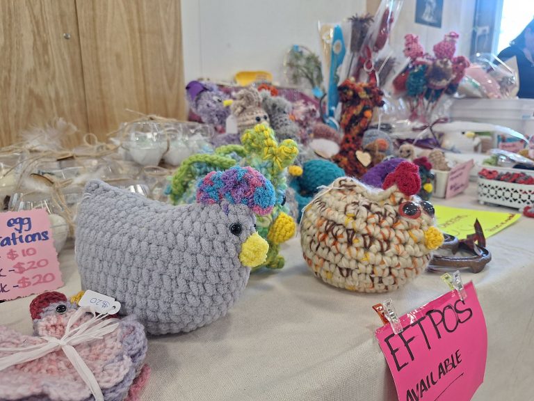 Handmade crochet chickens on a craft stall